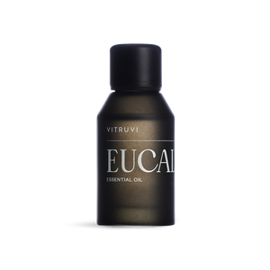 Aceite esencial de eucalipto Vitruvi 100% puro en botella negra para aromaterapia y difusor.